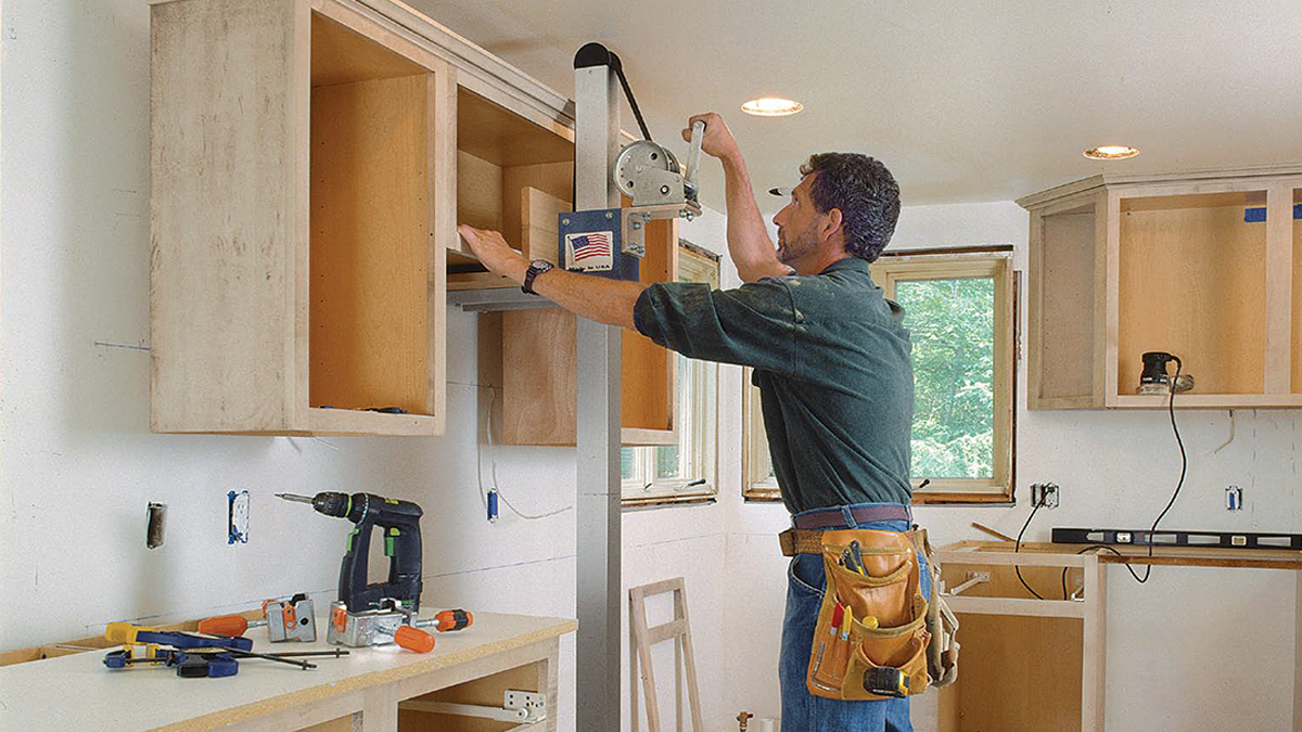 Guy working on Cabinets